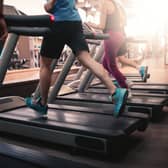 People running in machine treadmill at fitness gym club (Adobe)