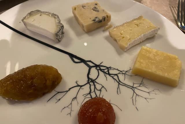 The cheese plate complete with a slice of blue murder on it