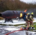 Firefighters used foam to extinguish a simulated aircraft blaze