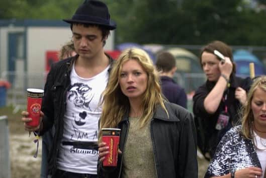 Kate Moss and Pete Doherty walk backstage on the second day of the Glastonbury Music Festival 2005