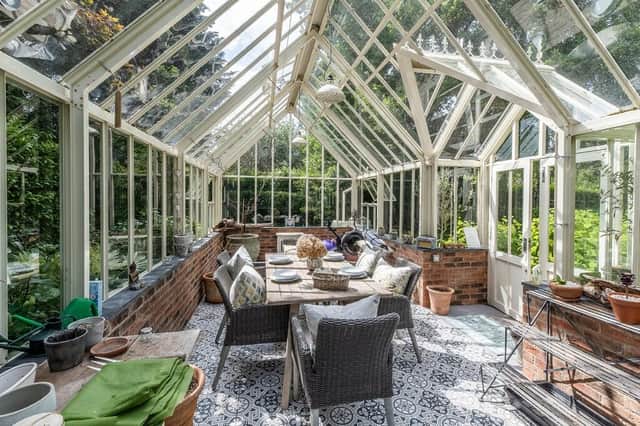 We're obsessed with the property's stunning Victorian greenhouse that doubles up as a dining space