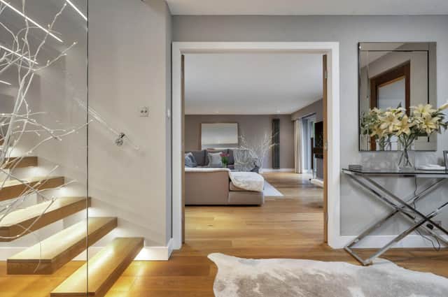 We love the contemporary hallway and stunning glass staircase 