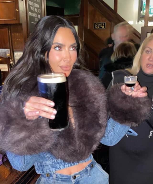 Kim Kardashian holds a pint of Guinness in a UK pub. Nottingham named the cheapest place in the UK for a shot of Baby Guinness. 