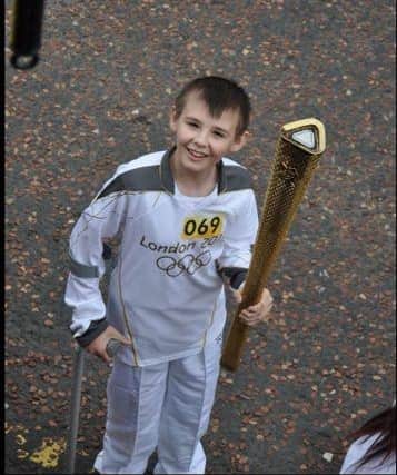 Kieran Maxwell carrying the Olympic torch in 2012.